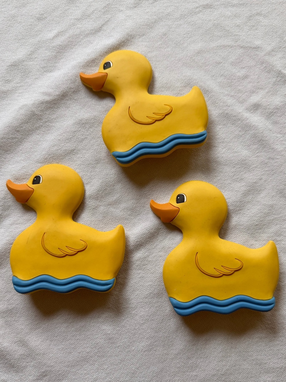 Three Vintage Yellow Rubber Duck Bath Toys with Blue Waves